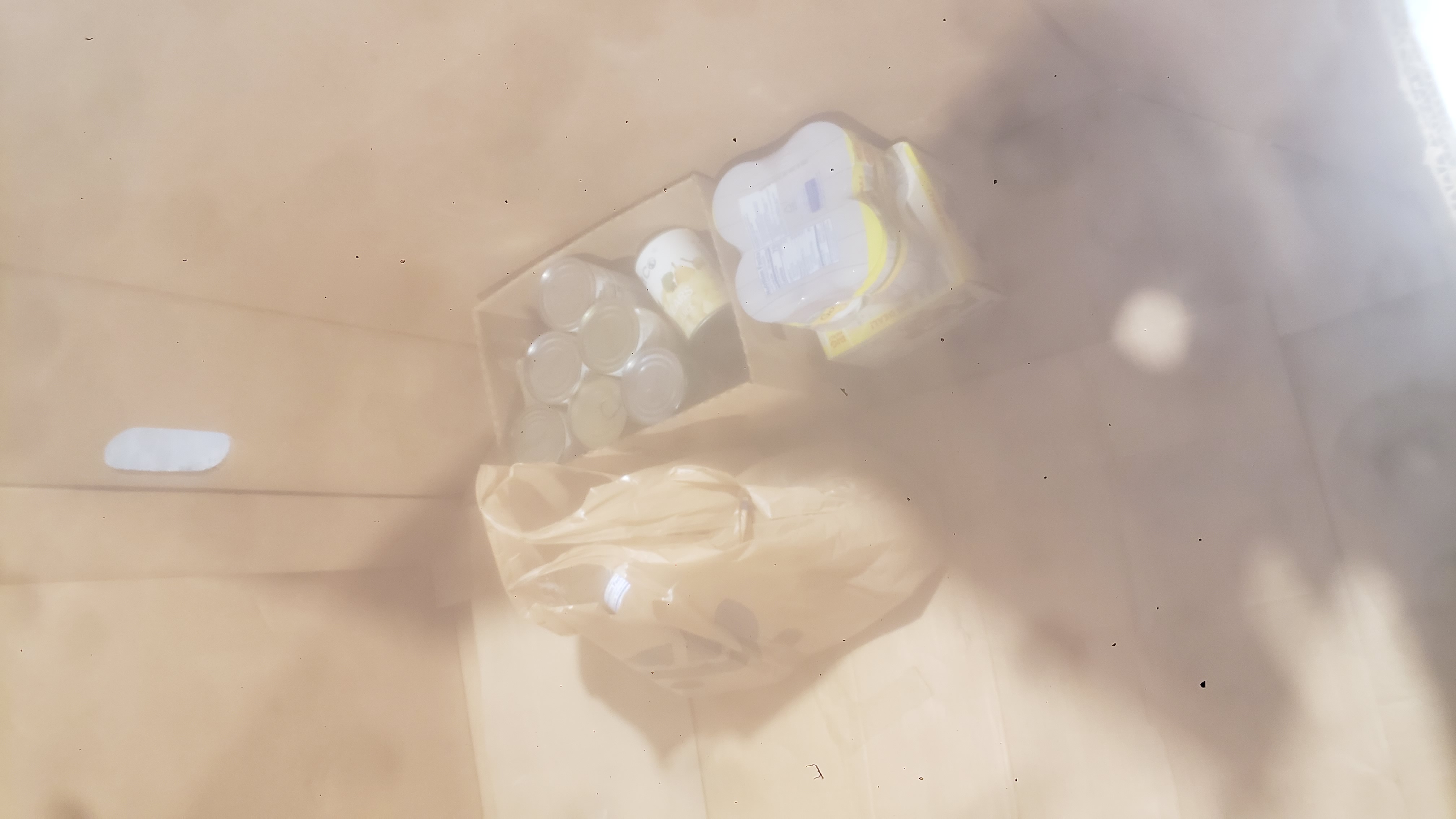 Canned goods in a cardboard container.